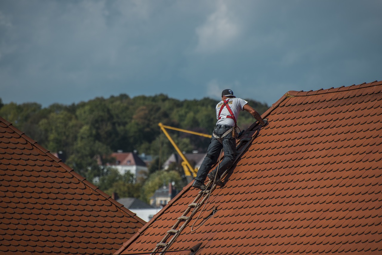 A person inspecting a roof.